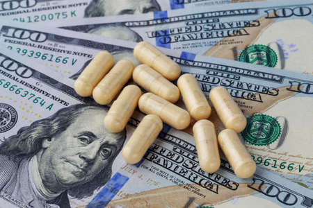 the medical pills are on a moneyの写真素材