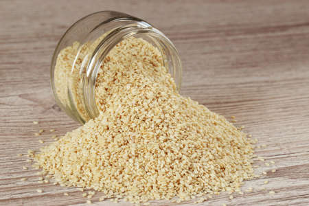 Sesame seed in a jar on wooden backgroundの写真素材