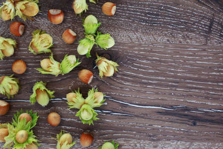 the handful of hazelnuts on a wooden tableの写真素材