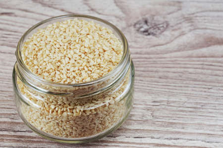 Sesame seed in a jar on wooden backgroundの写真素材