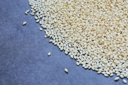 The scattered sesame seeds on a gray backgroundの写真素材