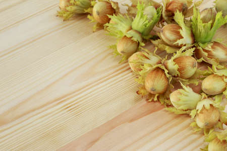 The handful of hazelnuts on a wooden tableの写真素材