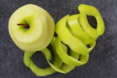 peel of apple on a grey background