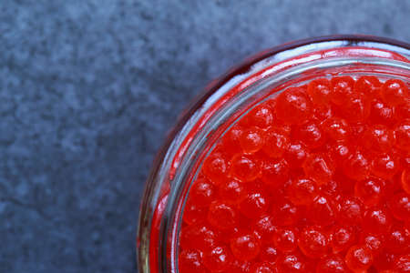 Red caviar in a jar on the table
