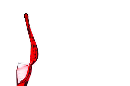 splash of red wine from goblet on a white backgroundの写真素材