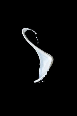 Splash of milk on a black backgroundの写真素材