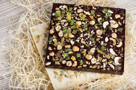 Homemade white and black chocolate on a wooden background