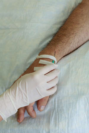 The hand with needle of medical dropperの写真素材