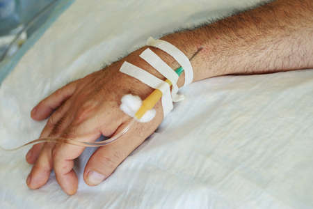 The hand with needle of medical dropper