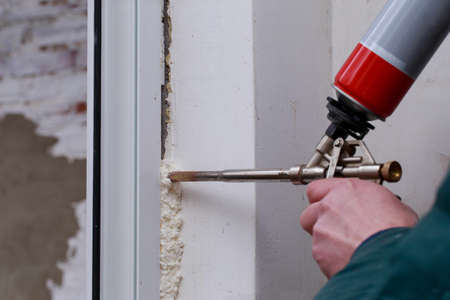 Using polyurethane foam in the installation of windowsの写真素材