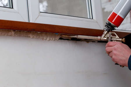 Using polyurethane foam in the installation of windowsの写真素材