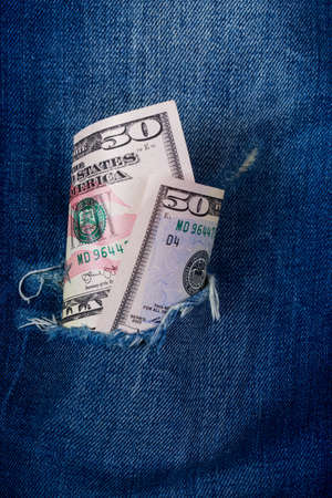 Fifty dollars banknote in a hole of jeans