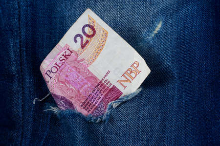 Twenty zloty in a hole of jeansの写真素材