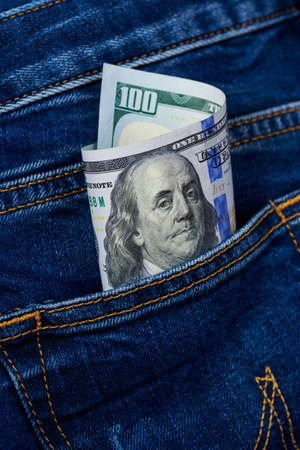 Hundred dollar bill in a jeans pocket