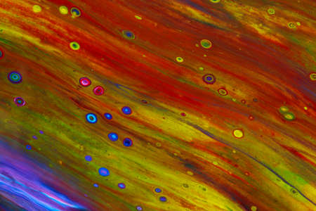 Abstract background of acrylic paint in yellow and red tones