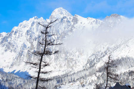 Panorama of beautiful snowy mountains against the blue sky