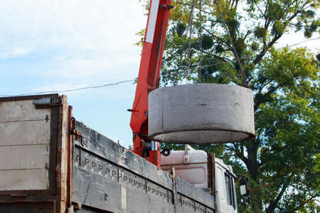 Crane with hooks raises heavy concrete structureの写真素材