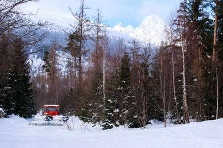 the ski slope preparation machine clears snow