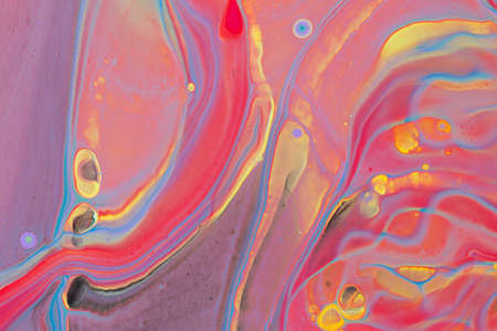 Abstract background of acrylic paint in blue red and yellow tones