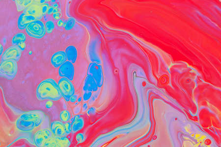 Abstract background of acrylic paint in blue red and yellow tones