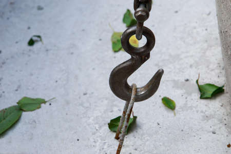 Large metal hook hooked on concrete structure