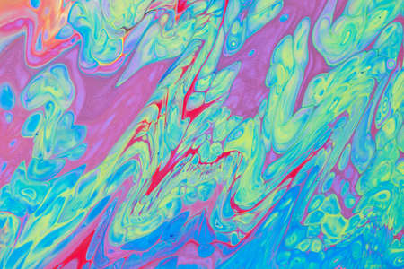 Abstract background of acrylic paint in blue red and yellow tones