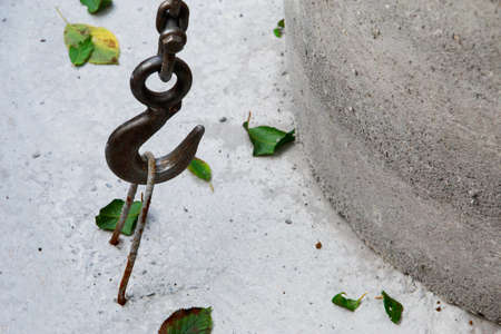 Large metal hook hooked on concrete structureの写真素材