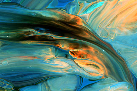 Abstract background of acrylic paints in orange and blue color tones