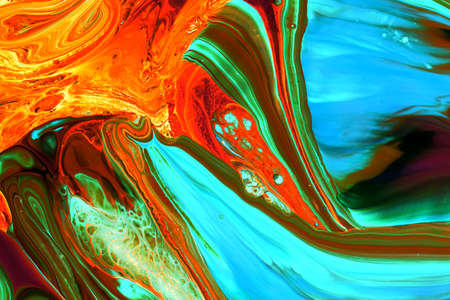 Abstract background of acrylic paints in orange and green color tones