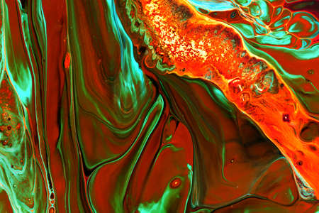Abstract background of acrylic paints in orange and green color tones