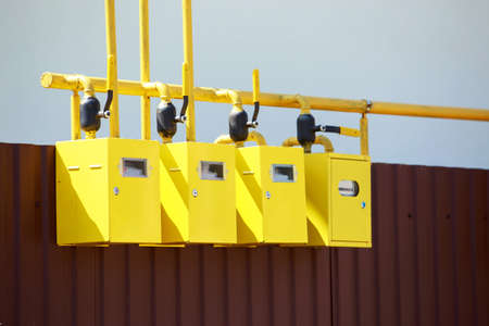 Row of residential natural gas meters on exterior wall