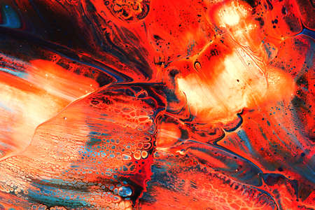 Abstract background of acrylic paints in orange and blue color tones
