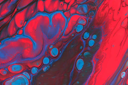 Abstract background of acrylic paints in red and blue color tones