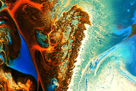 Abstract background of acrylic paints in orange and blue color tones