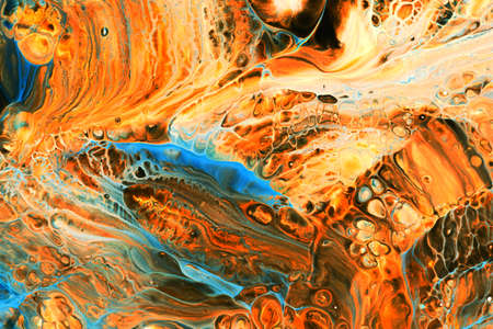 Abstract background of acrylic paints in orange and blue color tones