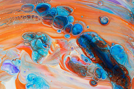 Abstract background of acrylic paints in blue and orange color tones