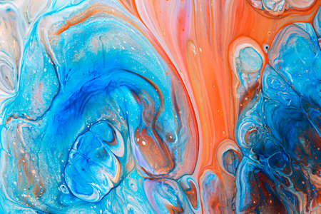 Abstract background of acrylic paints in blue and orange color tones