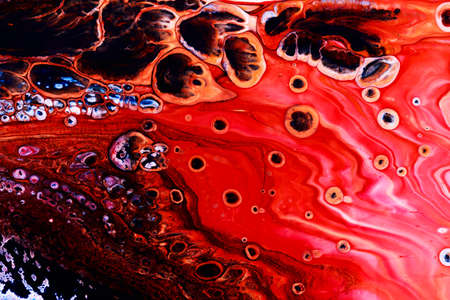 Abstract background of acrylic paints in red color tonesの写真素材