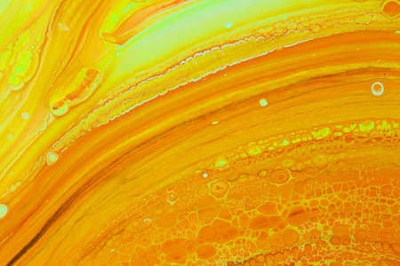 Abstract background of acrylic paints in orange and green color tones