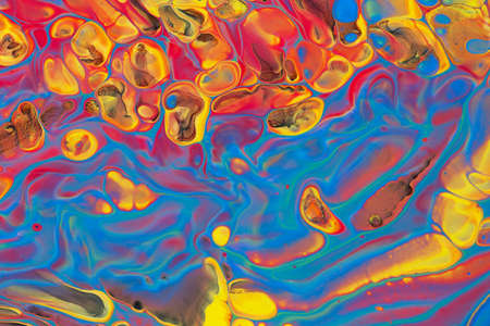 Abstract background of acrylic paint in blue red and yellow tones