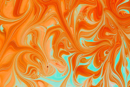 Abstract background of acrylic paints in aquamarine and orange color tonesの写真素材