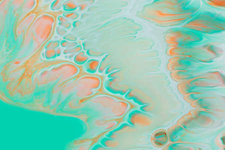 Abstract background of acrylic paints in aquamarine and orange color tonesの写真素材