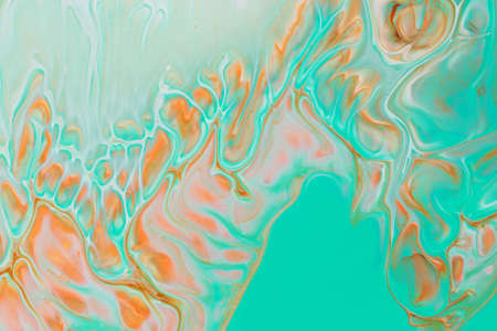 Abstract background of acrylic paints in aquamarine and orange color tones