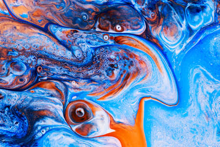 Abstract background of acrylic paints in blue and orange color tonesの写真素材