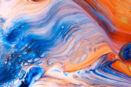 Abstract background of acrylic paints in blue and orange color tonesの写真素材