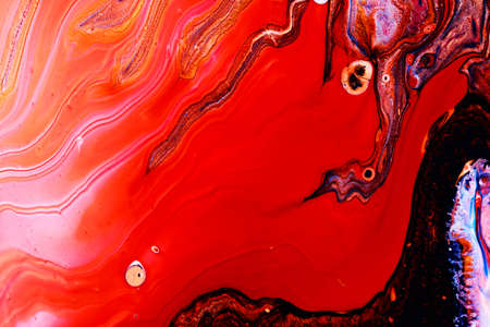 Abstract background of acrylic paints in red color tones