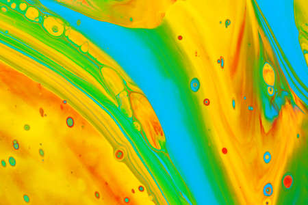 Abstract background of acrylic paints in orange and green color tones