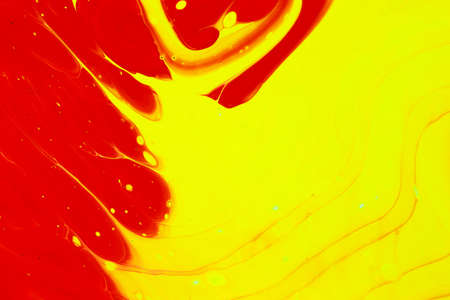 Abstract background of acrylic paints in red and yellow color tones