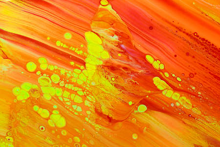 Abstract background of acrylic paints in orange and green color tones