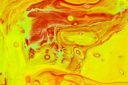 Abstract background of acrylic paints in orange and green color tones